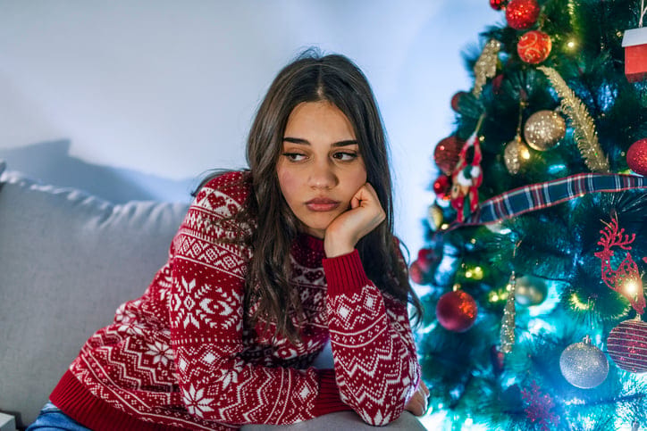 sad woman chin in hand at christmas