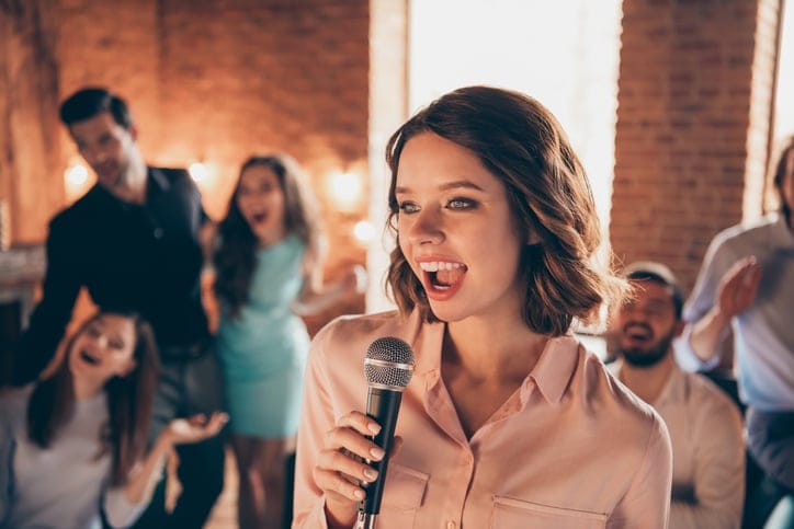 Close up photo best friends buddies six person couples karaoke night weekend vacation hang out vocal soloist she her ladies he him his guys wear dresses shirts formal wear sit sofa loft room indoors.