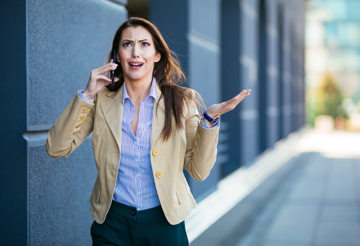 Angry woman talking on her phone.