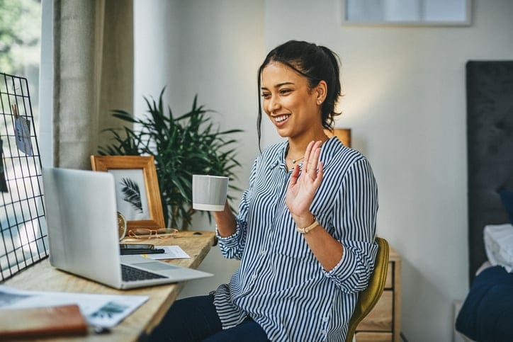 Shot of a young woman making a video call on a laptop at home
