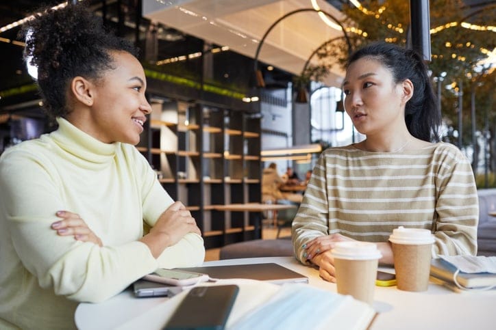 friends gossiping over coffee at cafe