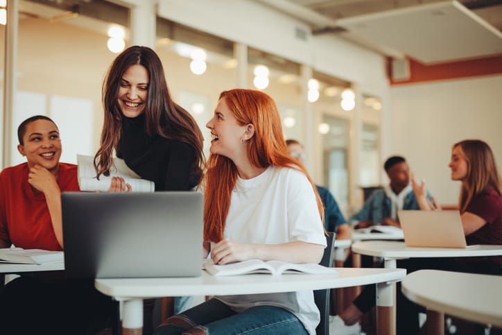 Two women chatting in class.