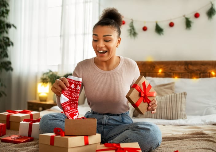 woman opening christmas gifts