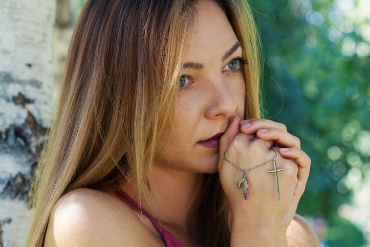 Religious young woman praying