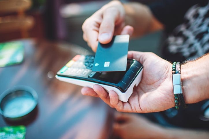 Man using a card at checkout.
