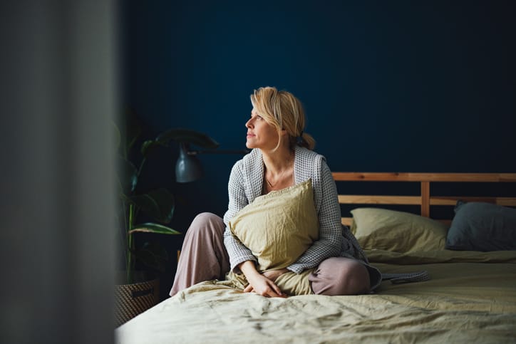 Smiling Woman Relaxing In Bed In The Morning