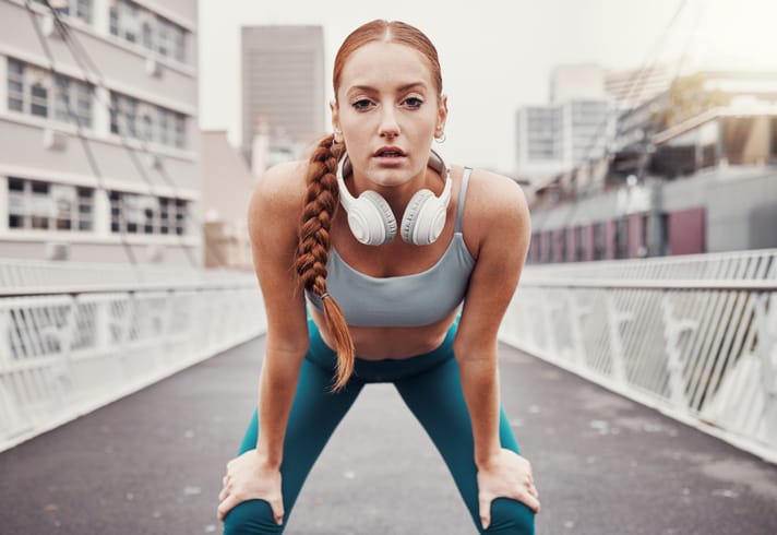 redhead woman out running looking determined