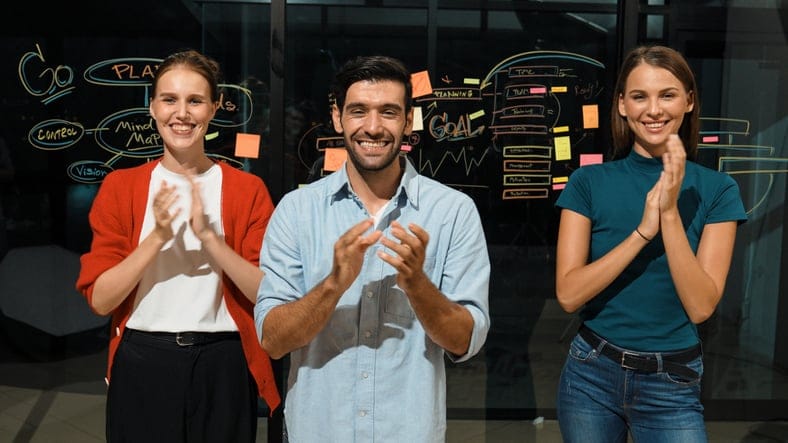 Group of businesspeople celebrate a successful project.