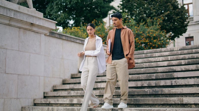 man and woman walking down stairs outside