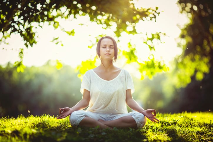 Woman doing yoga in the park.
