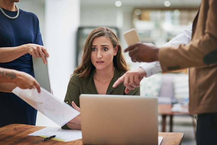 female worker given instructions by colleagues