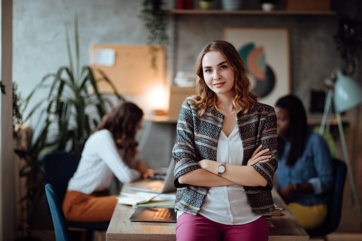 Woman with crossed arms in office.