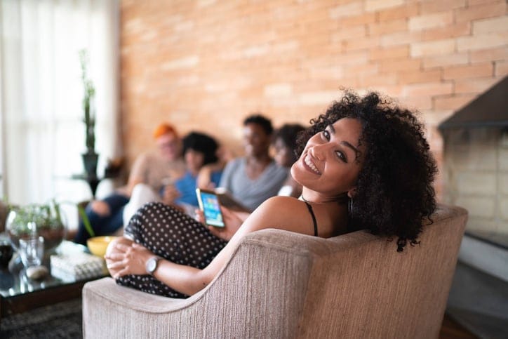 smiling woman looking back over chair