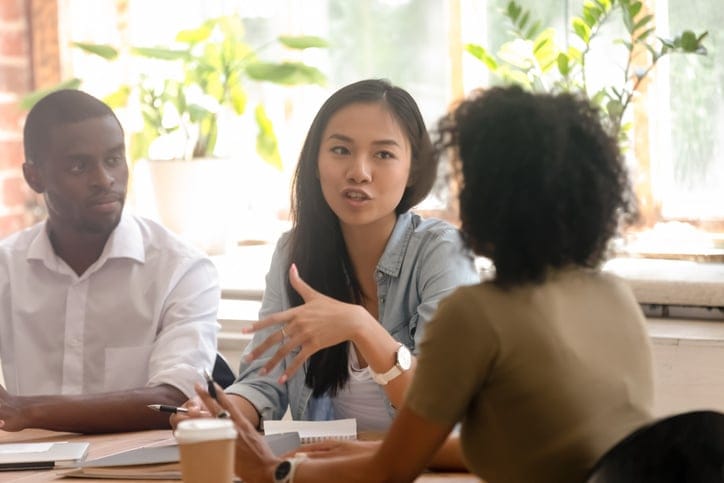 colleagues chatting in business meeting