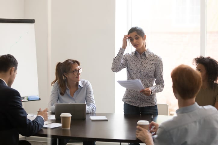 woman in business meeting looking stressed