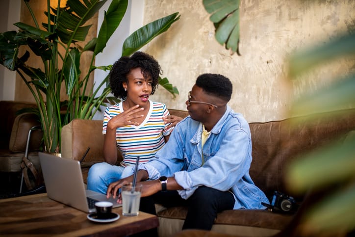 Young people having a chat at the bar.