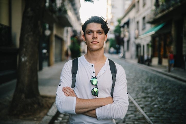 Handsome young man standing and posing in the streets of Buenos Aires, Argentina.