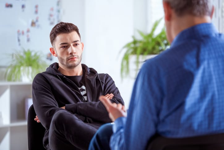 guy with crossed arms listening