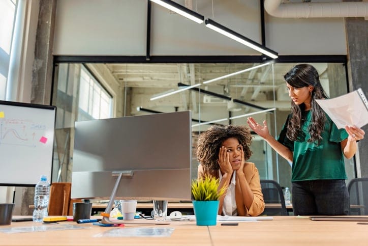 Two female colleagues chatting.