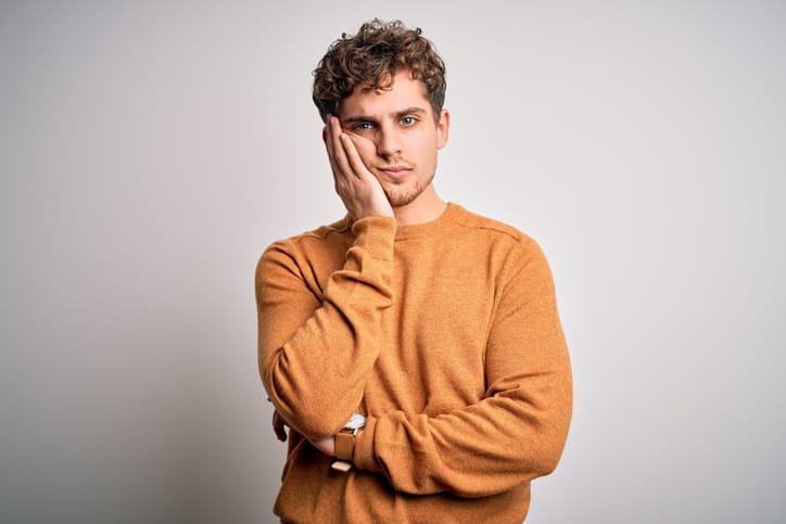 guy with his palm on his cheek
