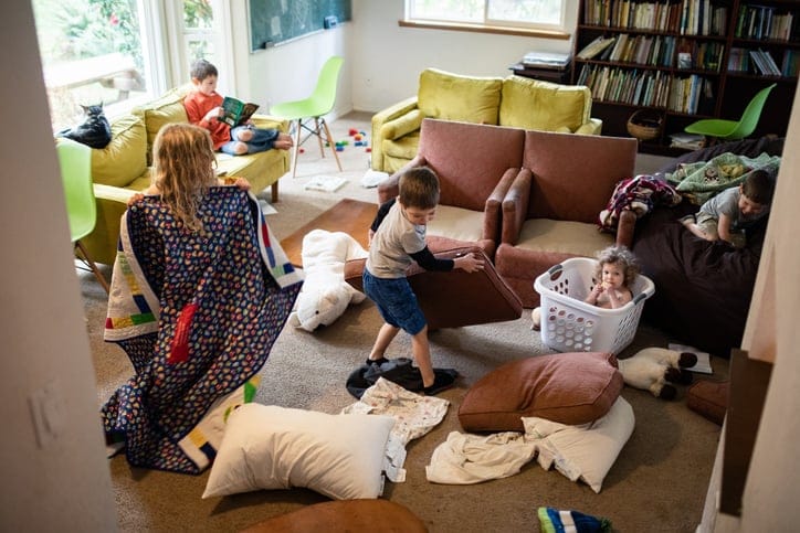 Chaotic family in their messy living room.
