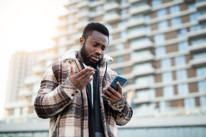 Frustrated guy looking at his texts.