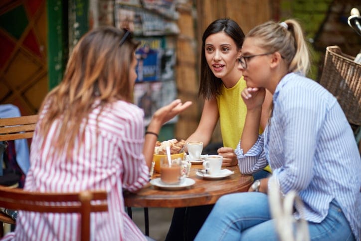 woman telling female friends a story