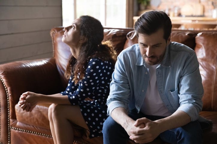 couple arguing sitting on couch