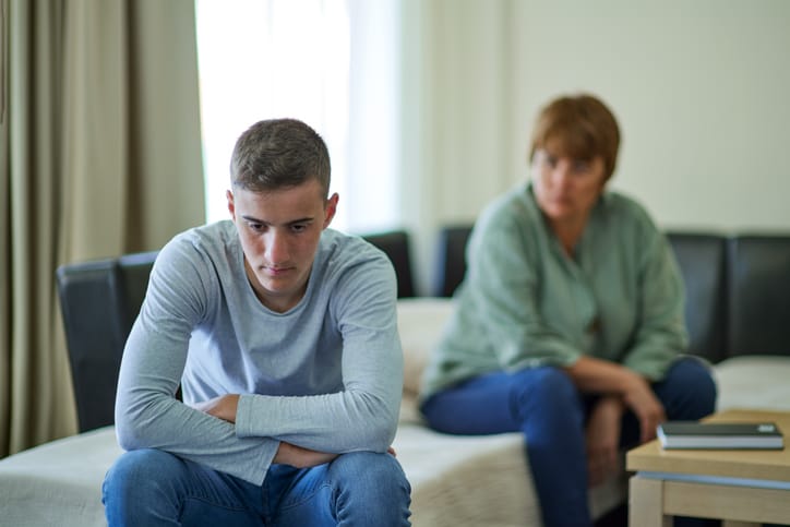 Mother talking with her upset son at home