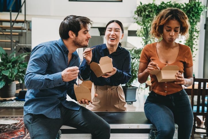 Young adult creative team of people during a lunch break in their coworking space