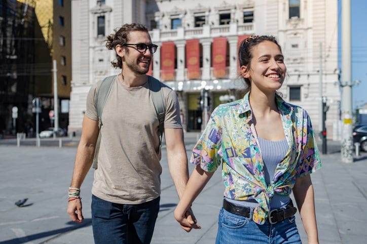 couple walking hand in hand on vacation