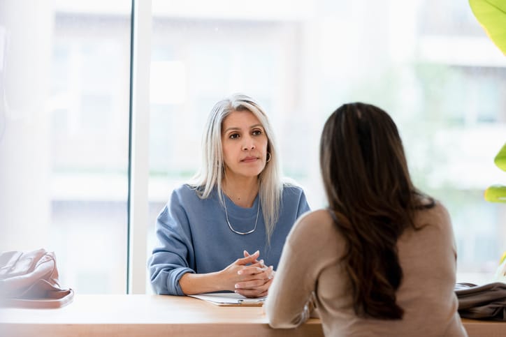 two women talking in office