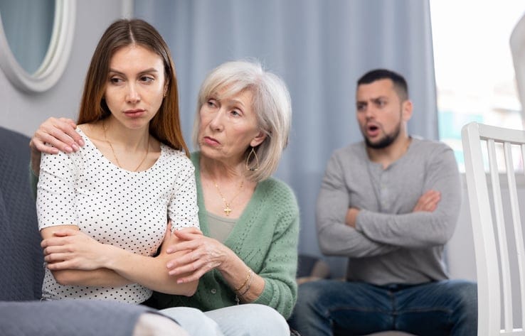 Elderly mother comforts her adult daughter after her quarrel with her husband