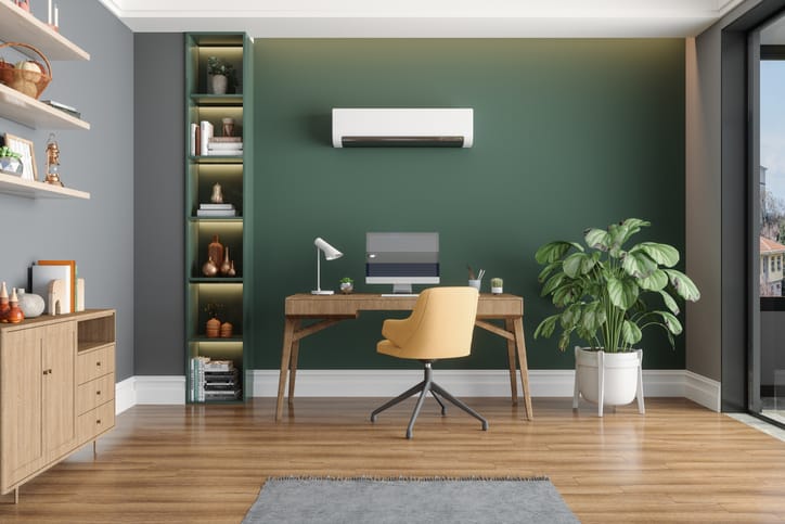 Home Office Interior With Air Conditioner, Table, Desktop Computer And Wooden Cabinet