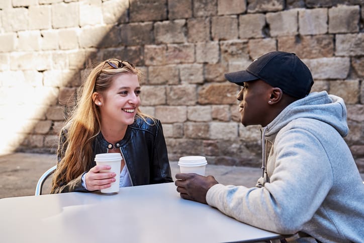 male and female having coffee together