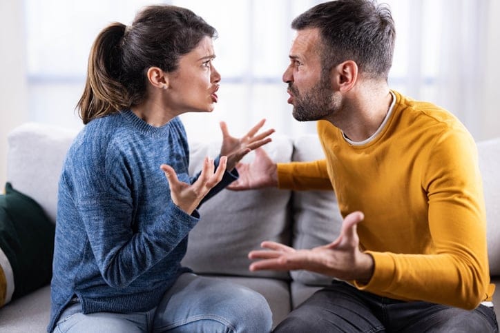 Frustrated couple having a fight during their relationship breakup at home.