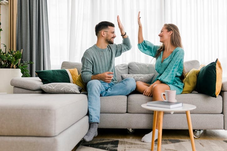 Shot of a happy young couple sharing a high five