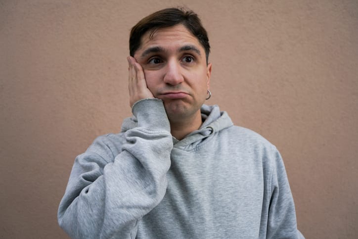 young man looking serious filled with regret