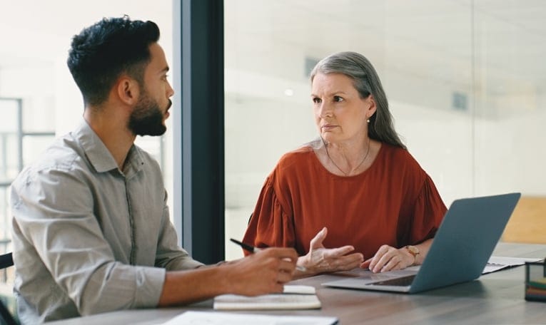 woman talking to man in office