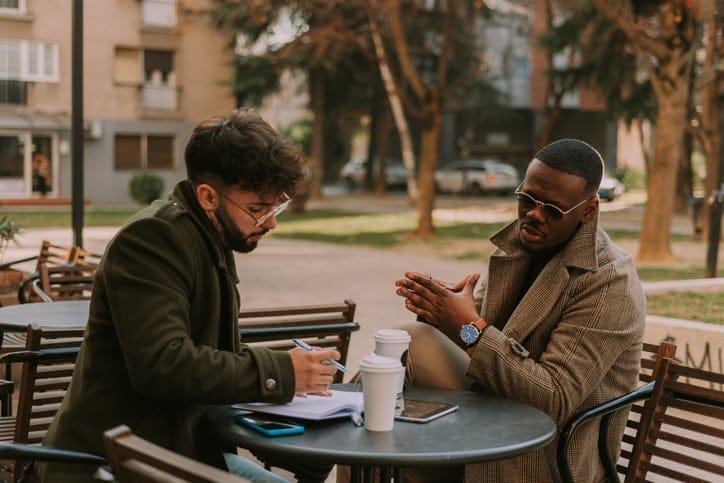 Male friends having coffee together.