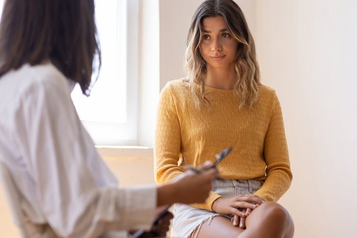 annoyed woman talkingn to therapist