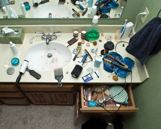 Messy bathroom counter and sink.