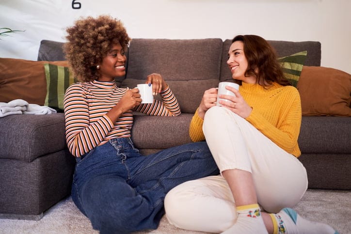 two female friends having a chat on the couch