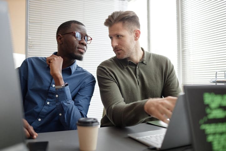 two colleagues working in office