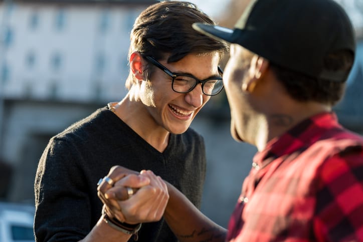 Two guys laughing and chatting.