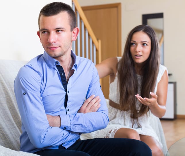 Angry young couple sulking on each other during quarrel at home