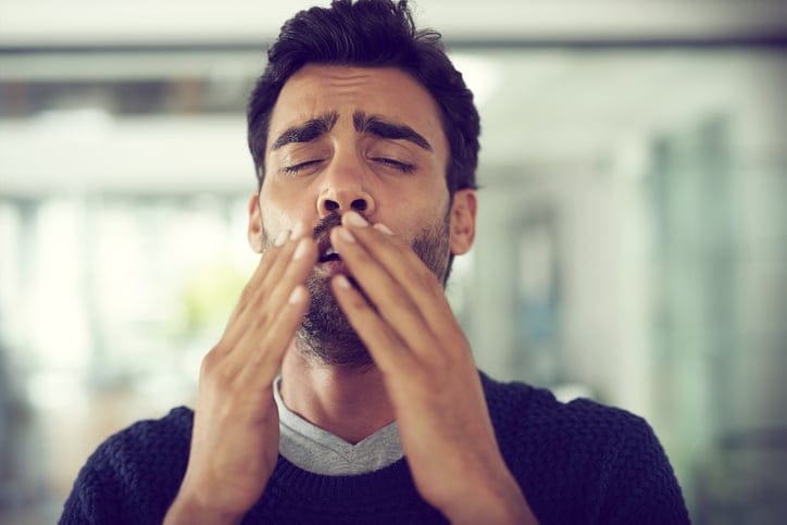 Man in mid-sneeze.