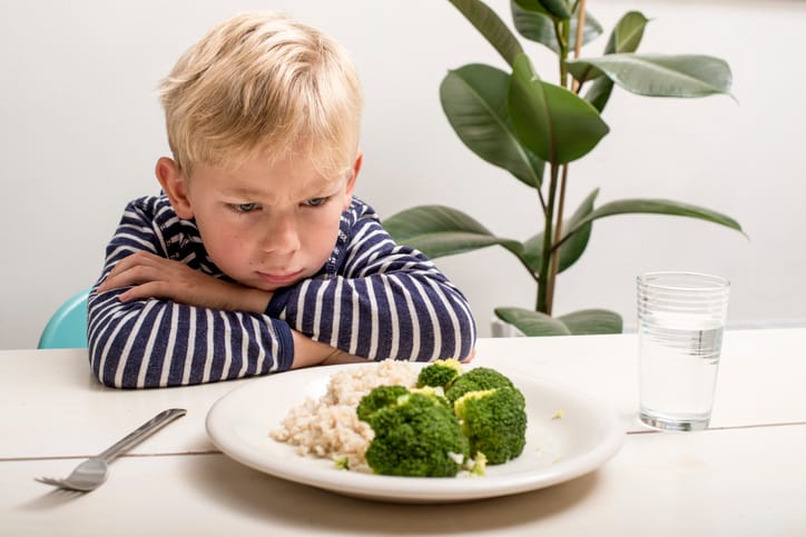 Sad kid who won't eat vegetables.