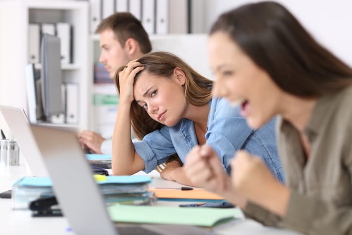 woman laughing at computer at work