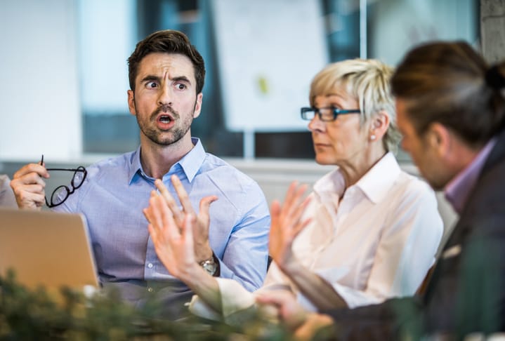 colleagues having a heated discussion during meeting